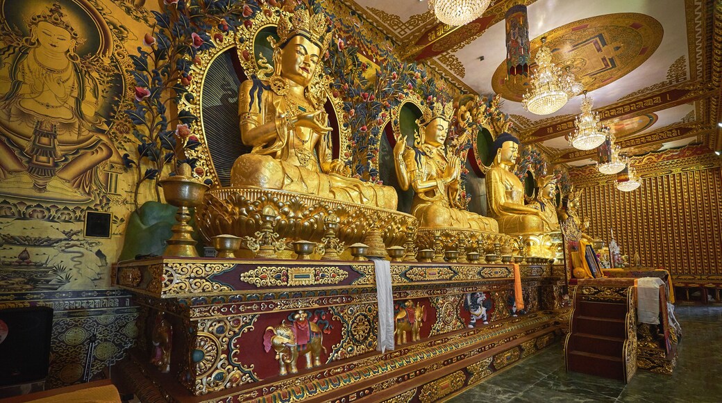 Golden buddha statues in the modern tibetan monastery in Dakshinkali, Nepal