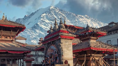 Traditional Tibetan architecture with snow-capped mountains in the background.