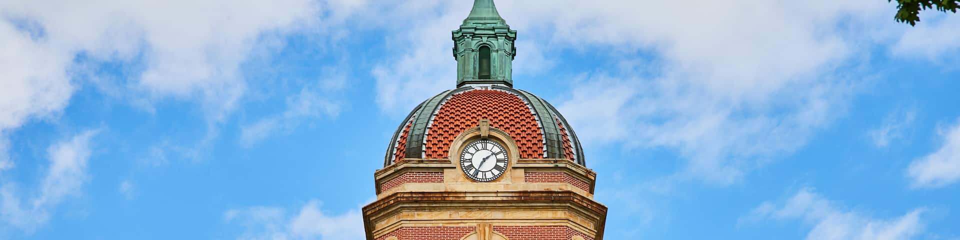 Top of Elkhart County courthouse with clock on blue sky day with fluffy white clouds, summer, IN-2