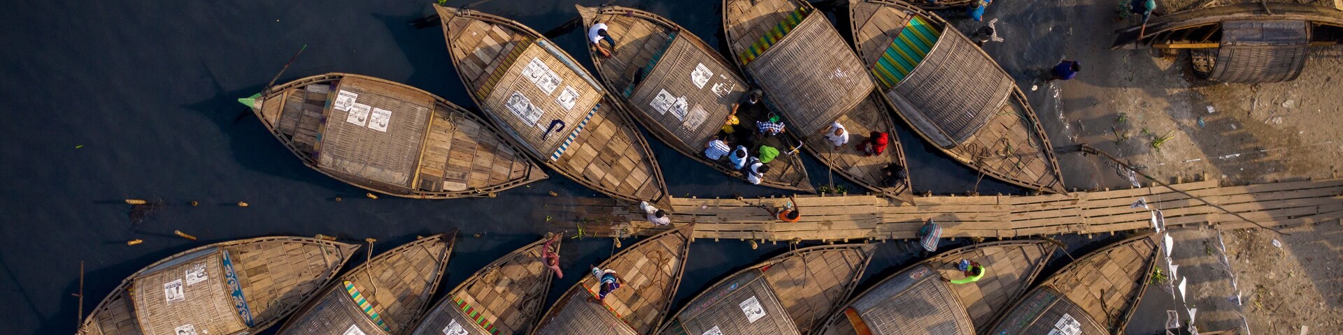 Aerial view of traditional fishing boat docked along Shitalakshya river in Bandar township, Dhaka state, Bangladesh.