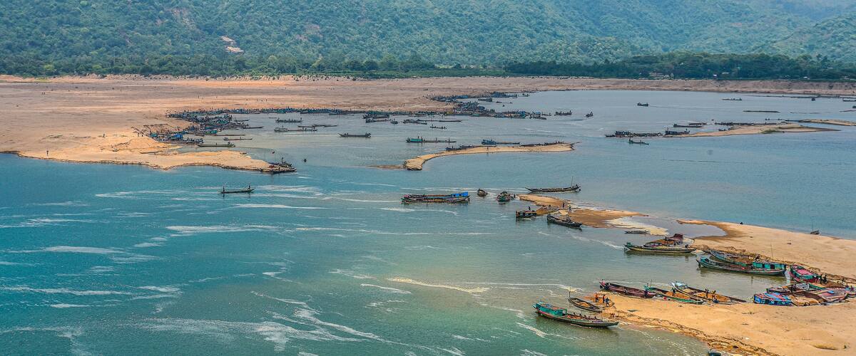 Spectacular view of Surma river with hills and sandy riverbank in Sunamganj district, Sylhet, Bangladesh.