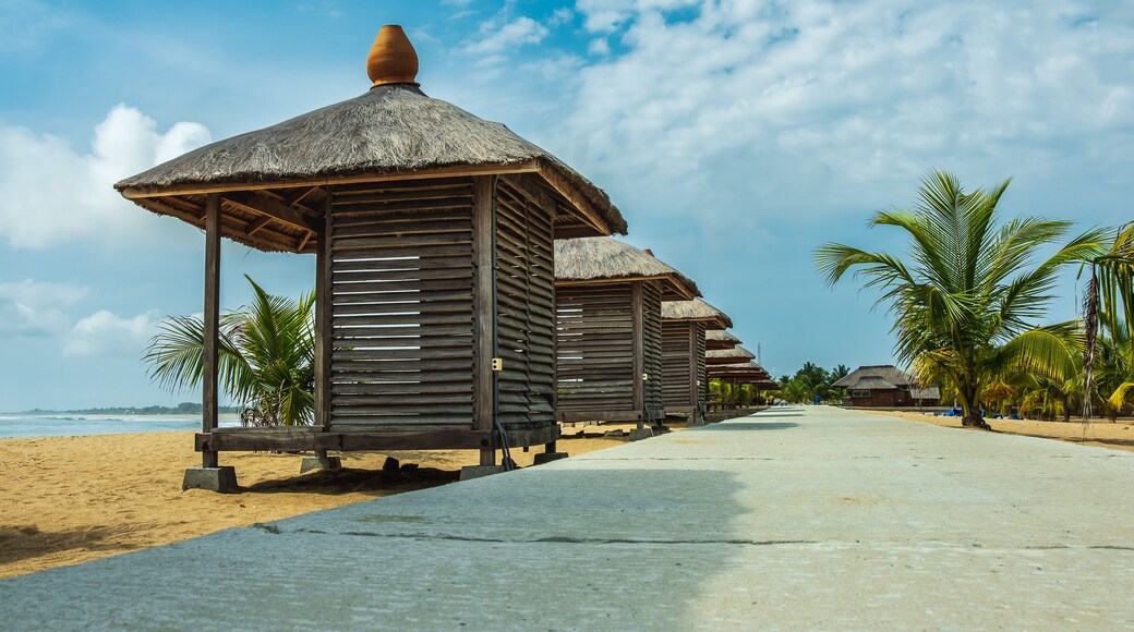 Pedestrian street with small bungalow houses where you can sit and admire the sea. Photo taken in Keta Ghana West Africa
