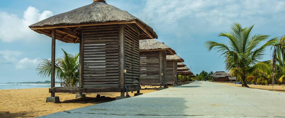 Pedestrian street with small bungalow houses where you can sit and admire the sea. Photo taken in Keta Ghana West Africa
