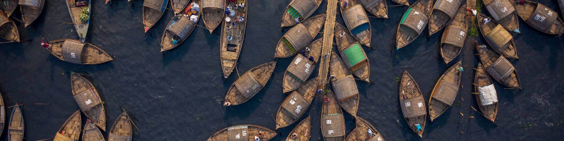 Aerial view of traditional fishing boat docked along Shitalakshya river in Bandar township, Dhaka state, Bangladesh.