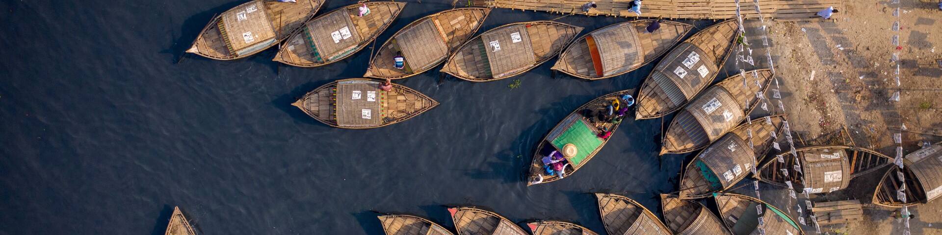 Aerial view of traditional fishing boat docked along Shitalakshya river in Bandar township, Dhaka state, Bangladesh.