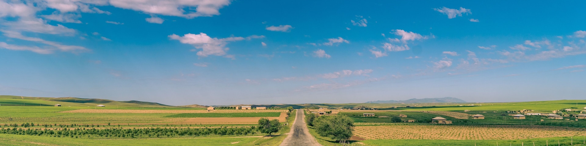 A long road with a clear blue sky above it