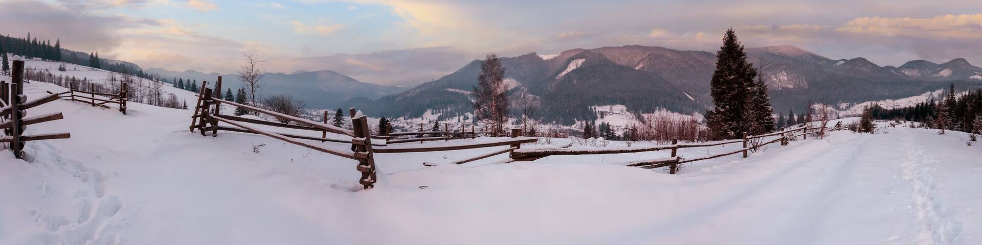 Daybreak morning dusk winter Carpathian mountain village Zelene in Black Cheremosh river valley between alp. View from rural snow covered path on hill slope, Verkhovyna district, Ukraine.