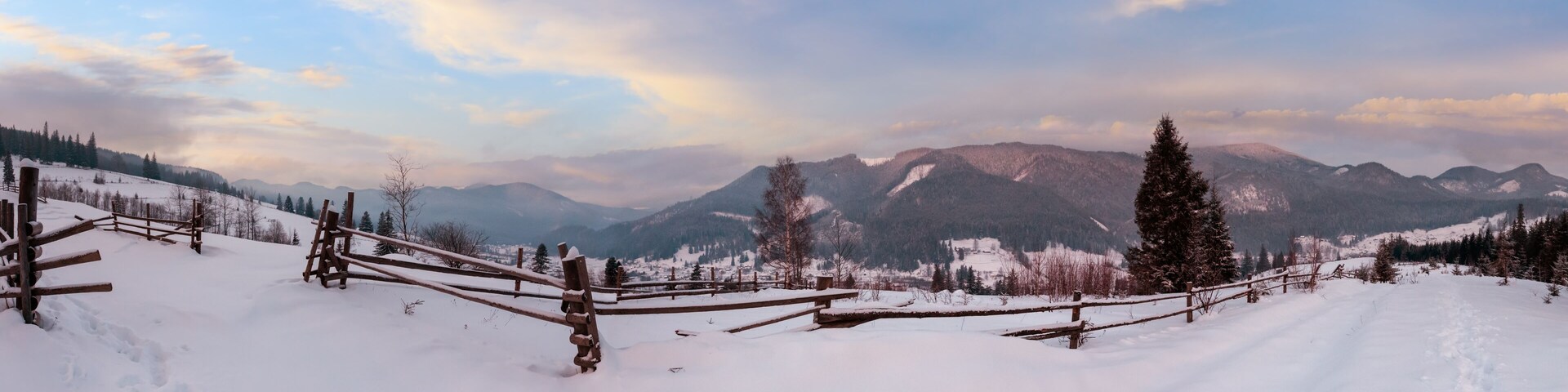 Daybreak morning dusk winter Carpathian mountain village Zelene in Black Cheremosh river valley between alp. View from rural snow covered path on hill slope, Verkhovyna district, Ukraine.