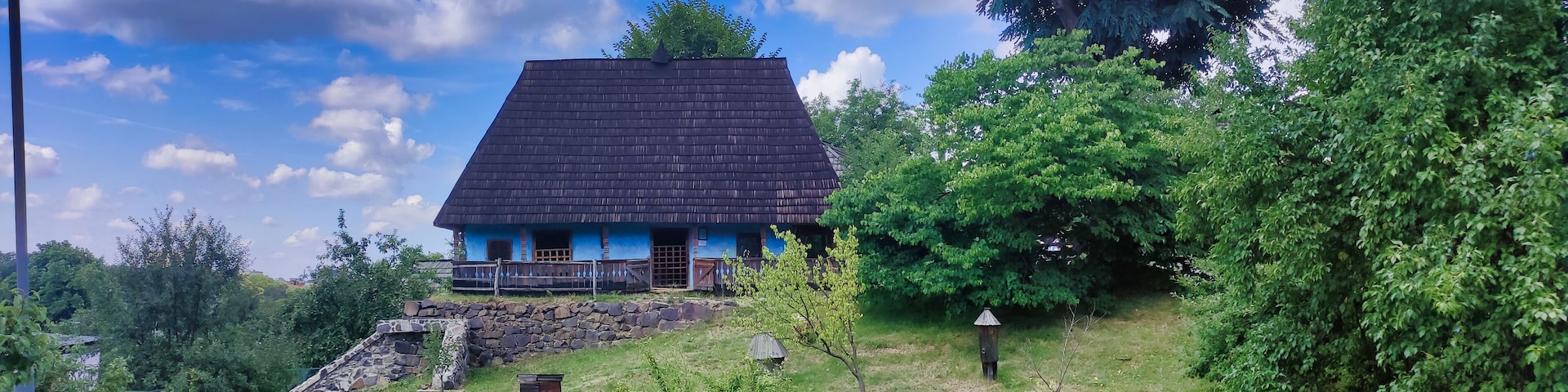 Rural house in Ukrainian style. Beehives near the house. Museum of Folk Architecture and Rural Life. Uzhhorod. Ukraine. Europe