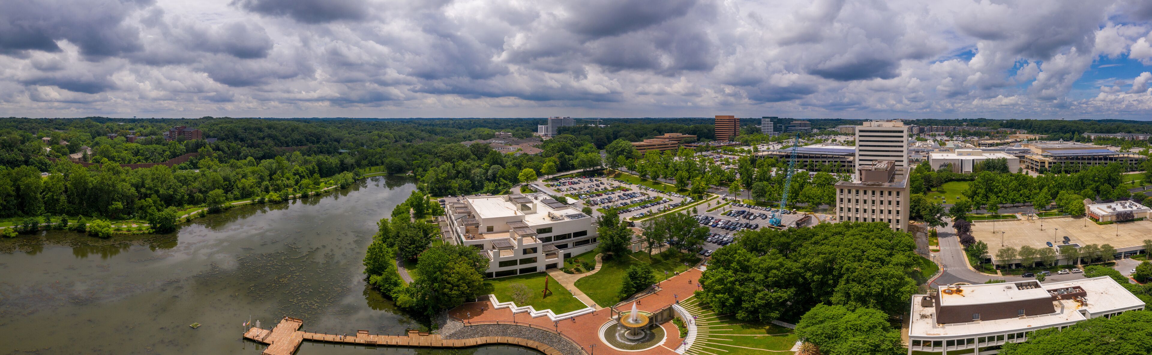 A river, a park, and a campus with buildings and parking lots.