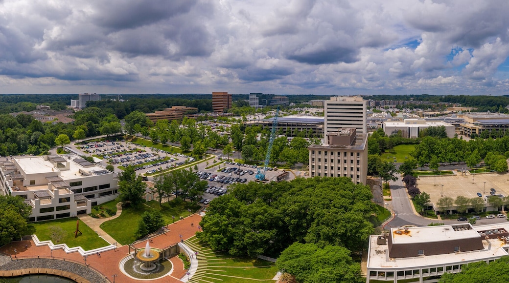 A river, a park, and a campus with buildings and parking lots.