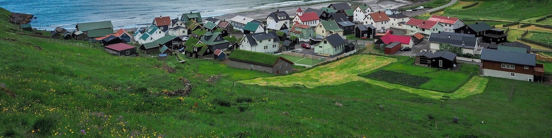 The tiny town of Tjørnuvík is the northernmost village on the island of Streymoy in the Faroe Islands. The road to get here is narrow and winding, but the views are SO worth it.