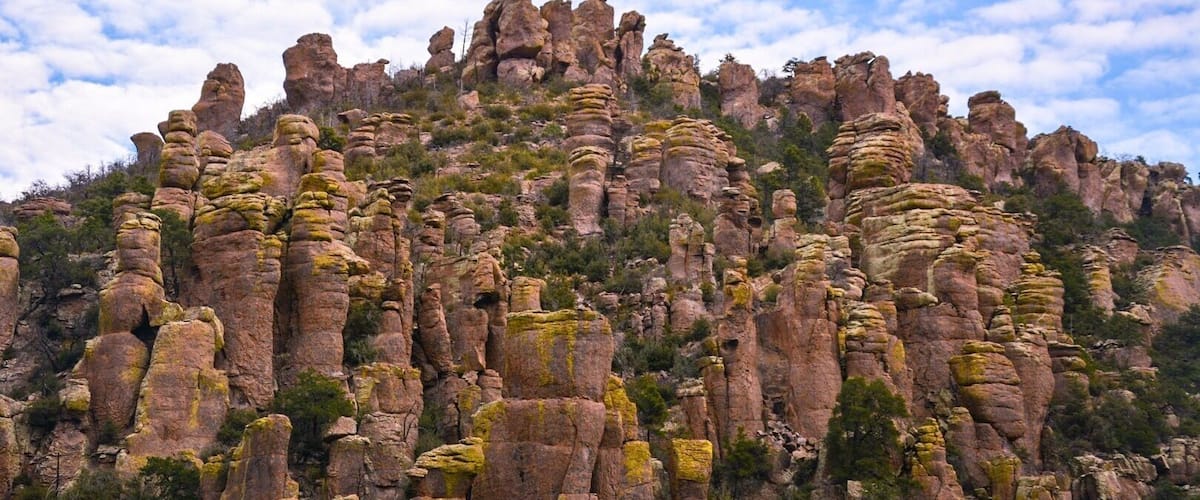 A rugged mountain with distinctive rock formations and sparse vegetation.