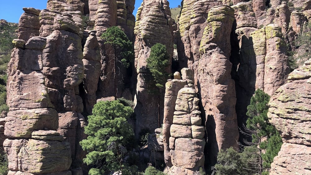 A rocky landscape with unique rock formations and green trees.