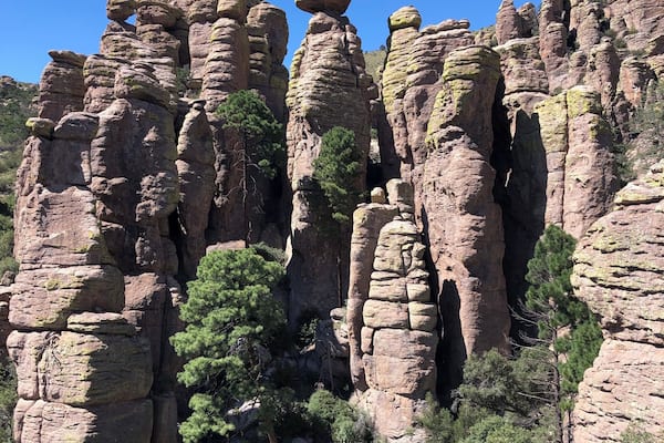 A rocky landscape with unique rock formations and green trees.