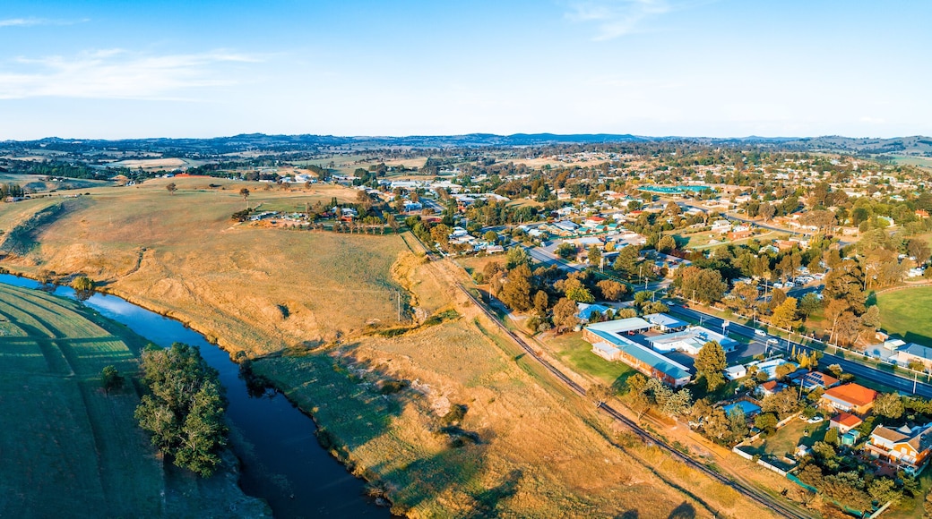 Beautiful aerial panorama of Yass town and river surrounded by grasslands at sunset