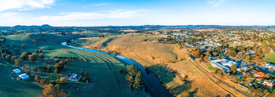 Beautiful aerial panorama of Yass town and river surrounded by grasslands at sunset