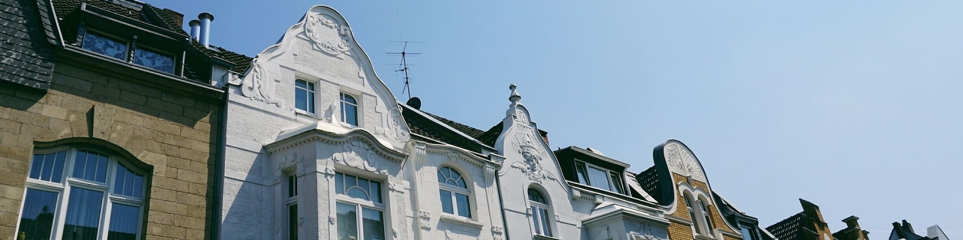 A row of historic buildings with ornate facades and large windows.