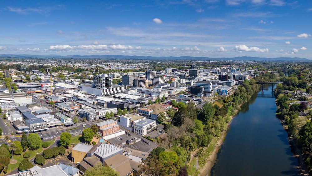 Aerial drone panoramic view looking towards the CBD as the Waikato River cuts through the city of Hamilton, in the Waikato region of New Zealand