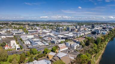 Aerial drone panoramic view looking towards the CBD as the Waikato River cuts through the city of Hamilton, in the Waikato region of New Zealand