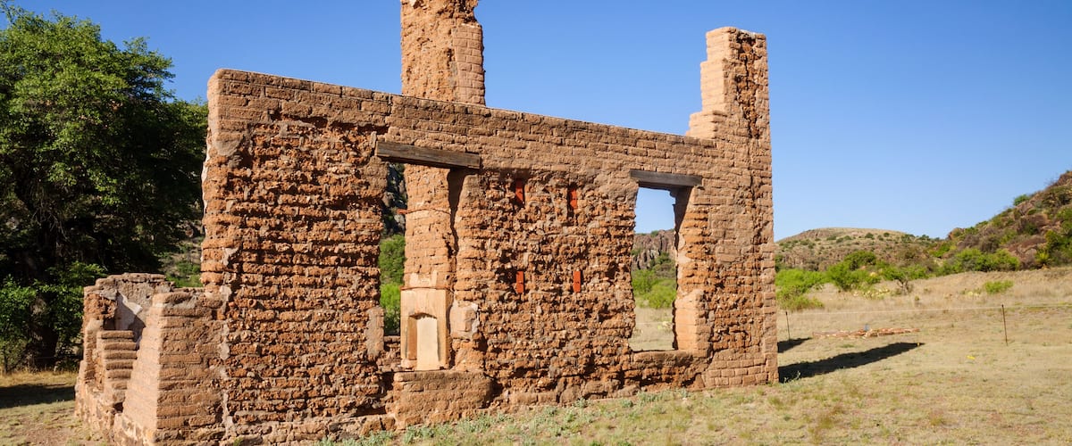 An ancient brick ruin with two standing columns and a partially intact wall.