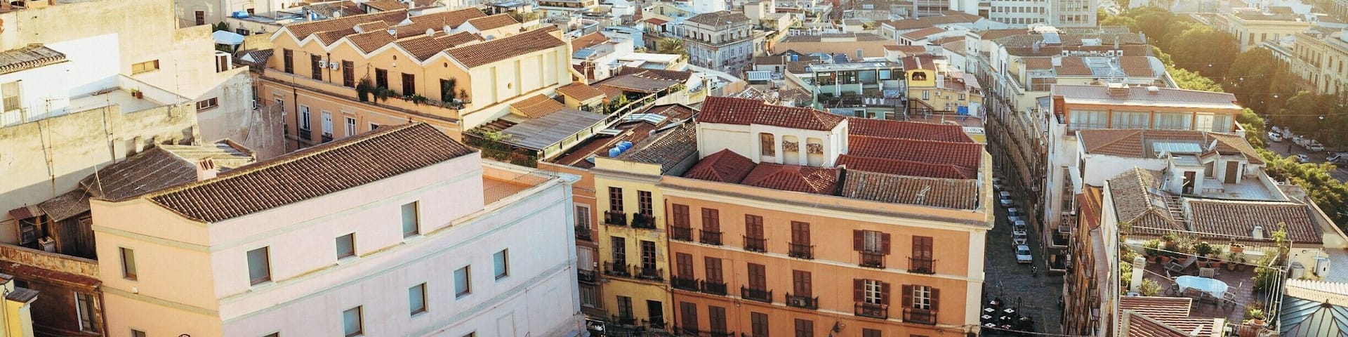 Panoramic view of the harbour of Cagliari from Viale Buoncammino during the golden hour.