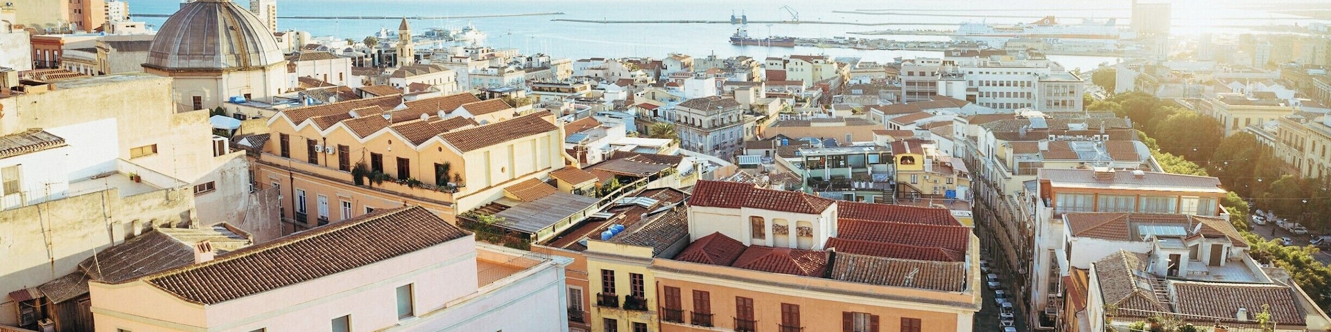 Panoramic view of the harbour of Cagliari from Viale Buoncammino during the golden hour.