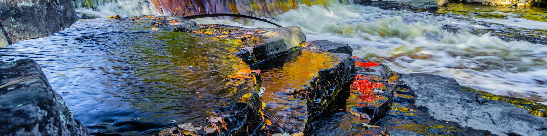 Autumn Waterfall Panorama. Gorgeous Upper Peninsula Michigan waterfall landscape at the Canyon Falls Scenic area between Baraga and Marquette, Michigan.