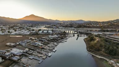 Aerial view of Corte madera Creek in Larkspur, Greenbrae, California, USA, at sunrise. Houses line the riverbank with docks and boats with Mount Tamalpais in the background.