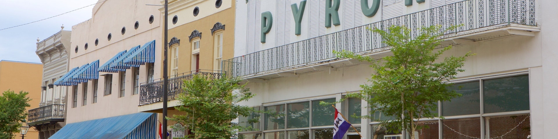A row of parked cars in front of a furniture store named Pyron's.