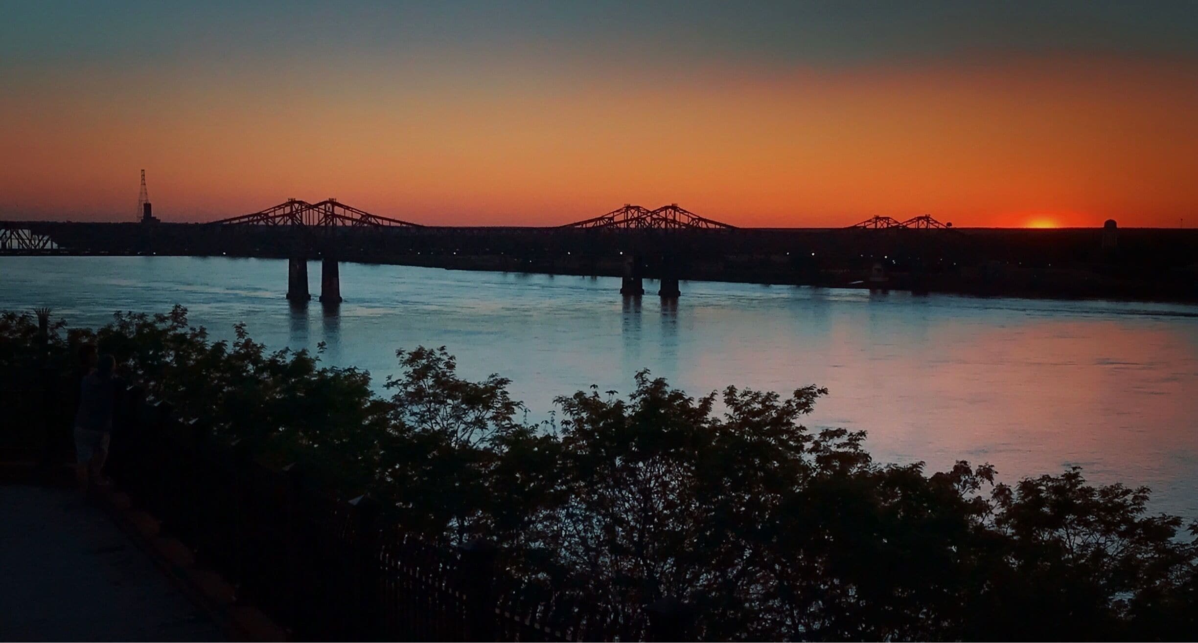 Sunset over the Mississippi River in Natchez, Mississippi.  Bridge connecting Mississippi and Louisiana.