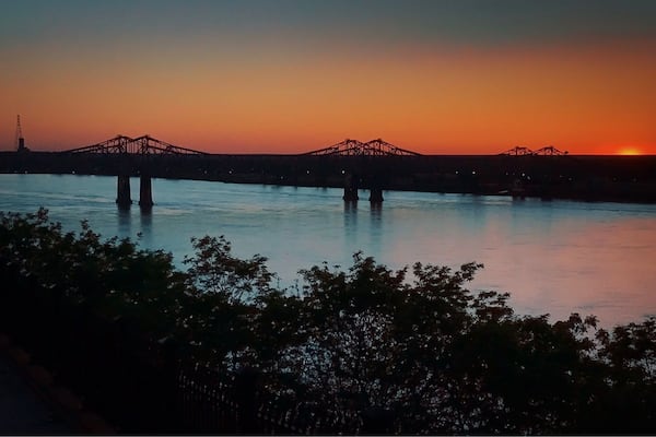 Sunset over the Mississippi River in Natchez, Mississippi. Bridge connecting Mississippi and Louisiana.
