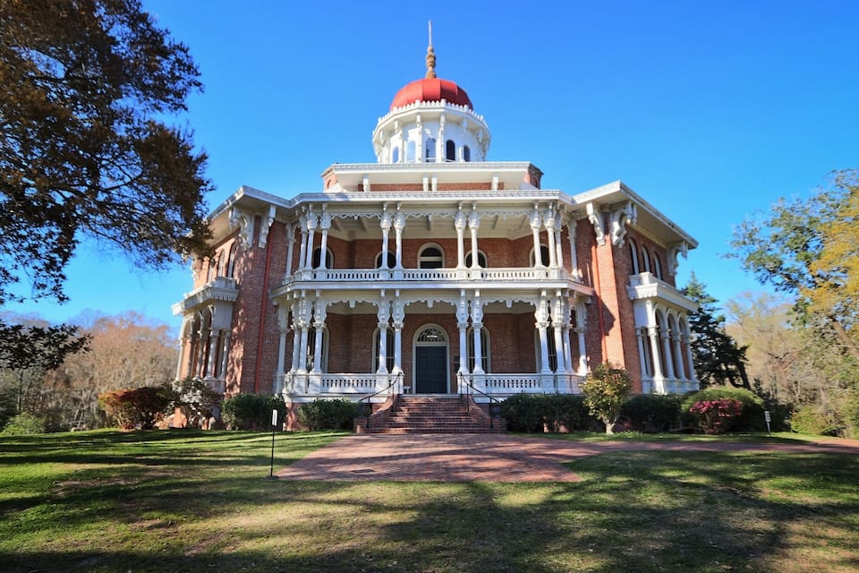 A large, historic building with a red dome and white columns.