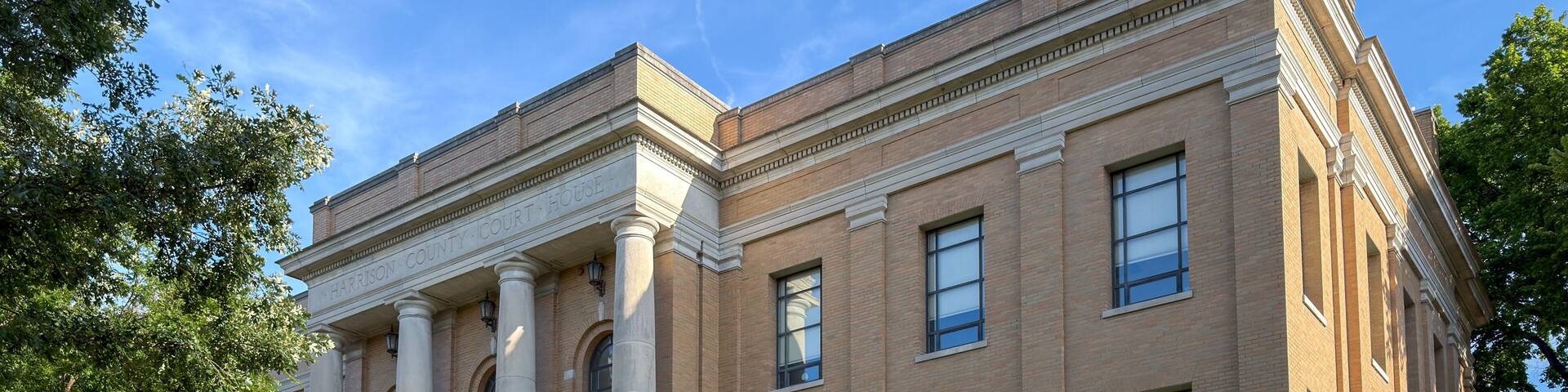 A courthouse with classical architecture, featuring columns and a prominent entrance.