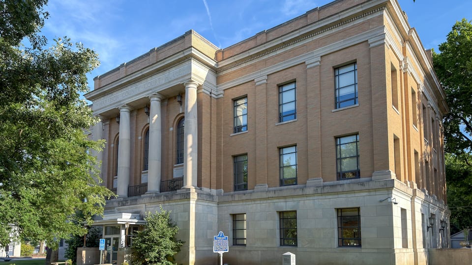 A courthouse with classical architecture, featuring columns and a prominent entrance.