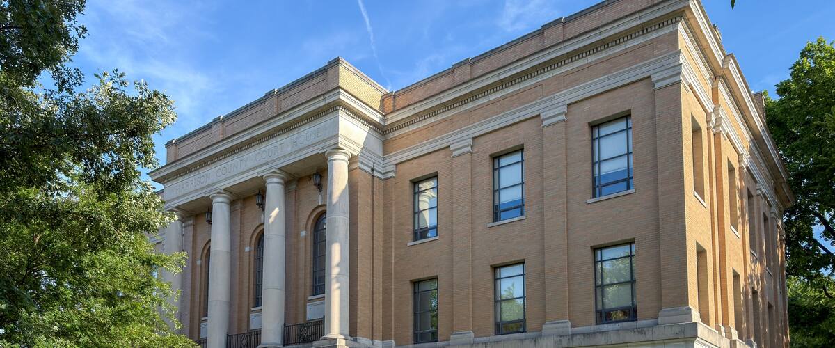 A courthouse with classical architecture, featuring columns and a prominent entrance.
