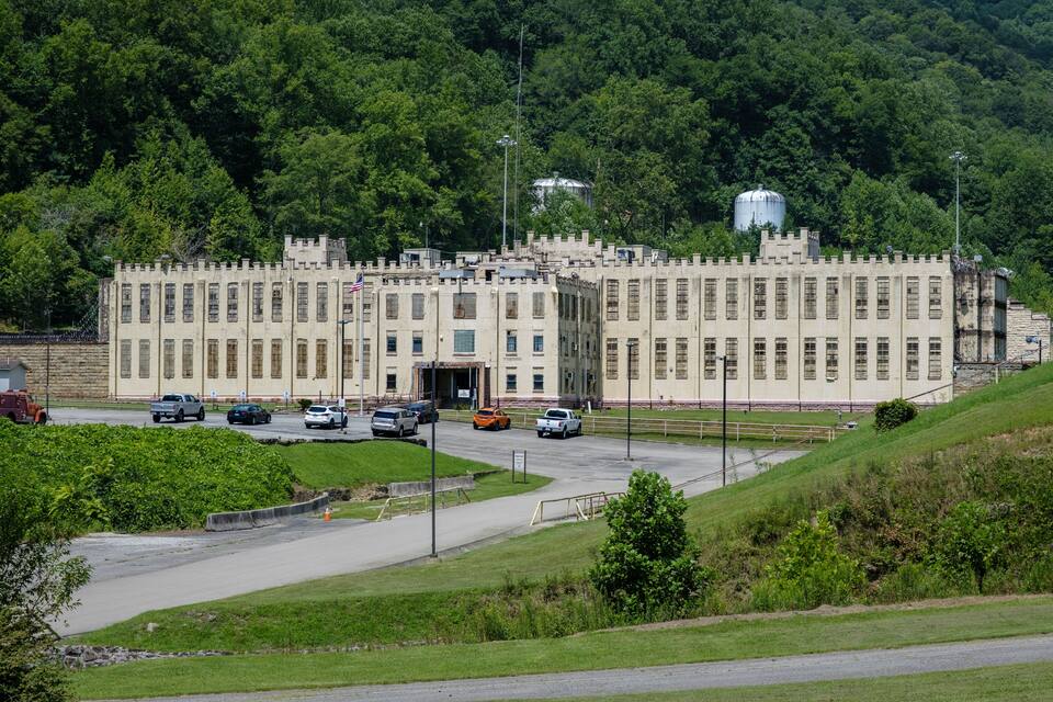 A large, castle-like building with a parking lot in front.
