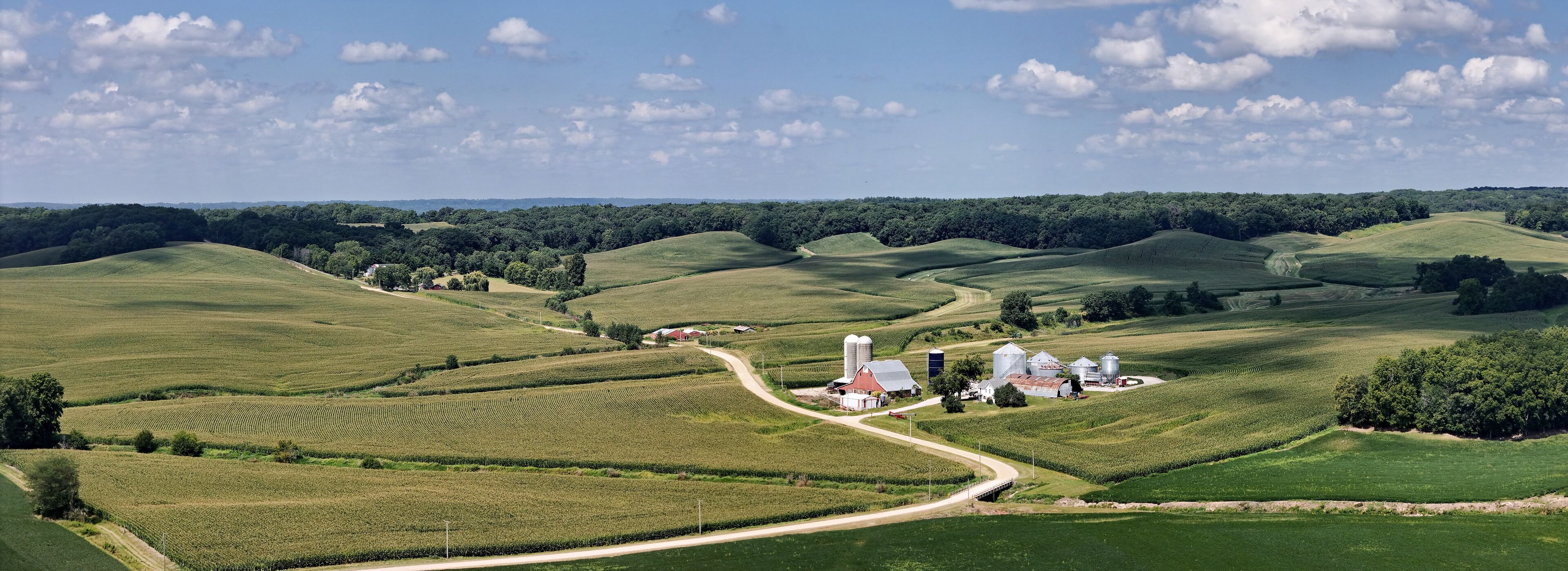 Farm fields panorama with homestead in the rolling hills of Northwest Illinois