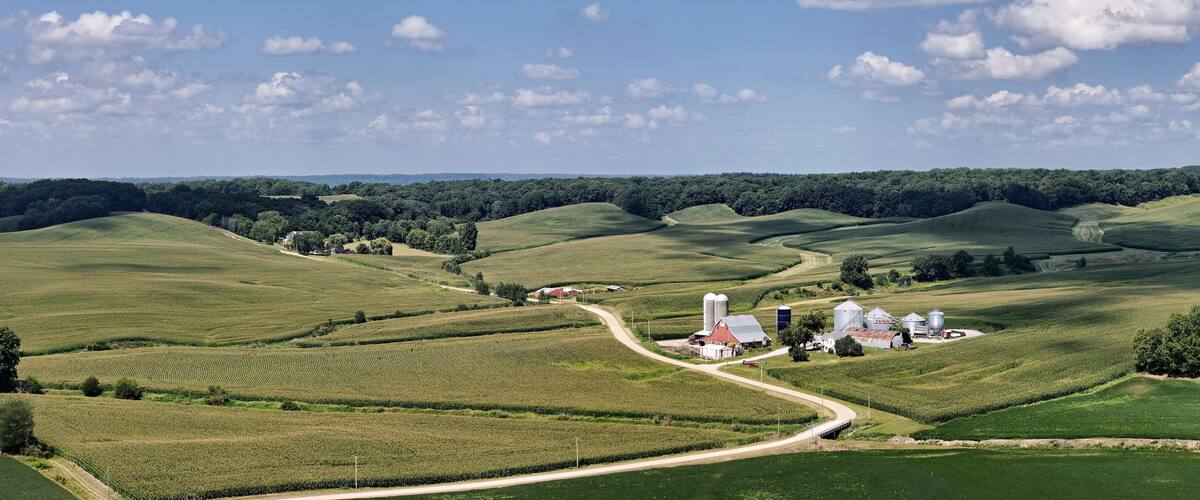Farm fields panorama with homestead in the rolling hills of Northwest Illinois