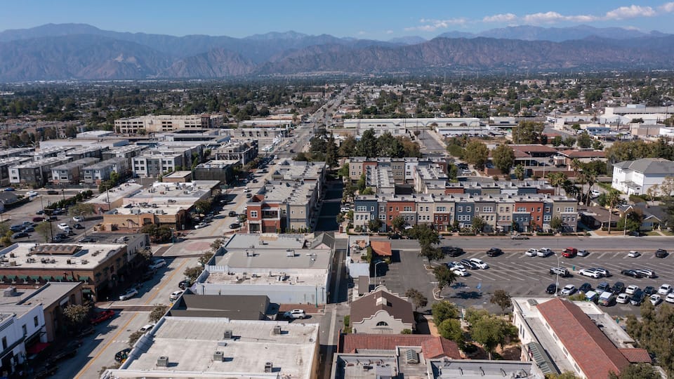 A cityscape with a mountain range in the background.