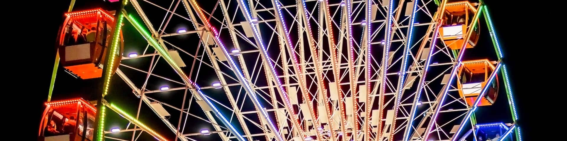 Ferris Wheel Spinning Round Illuminated in Night Sky