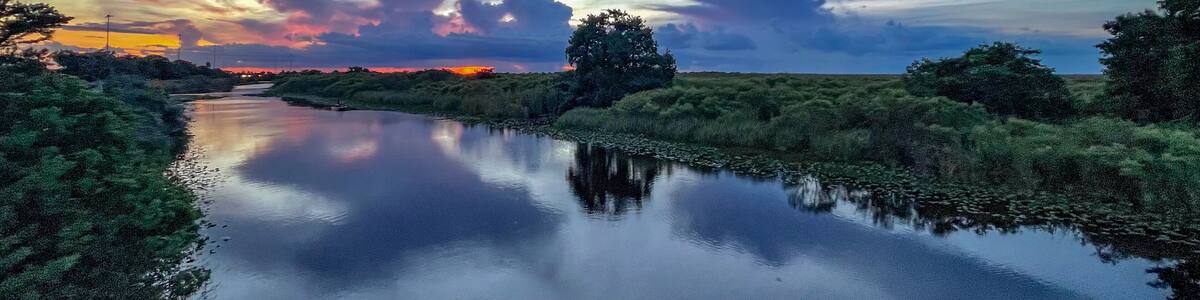 Swamp sunset and hurricane clouds