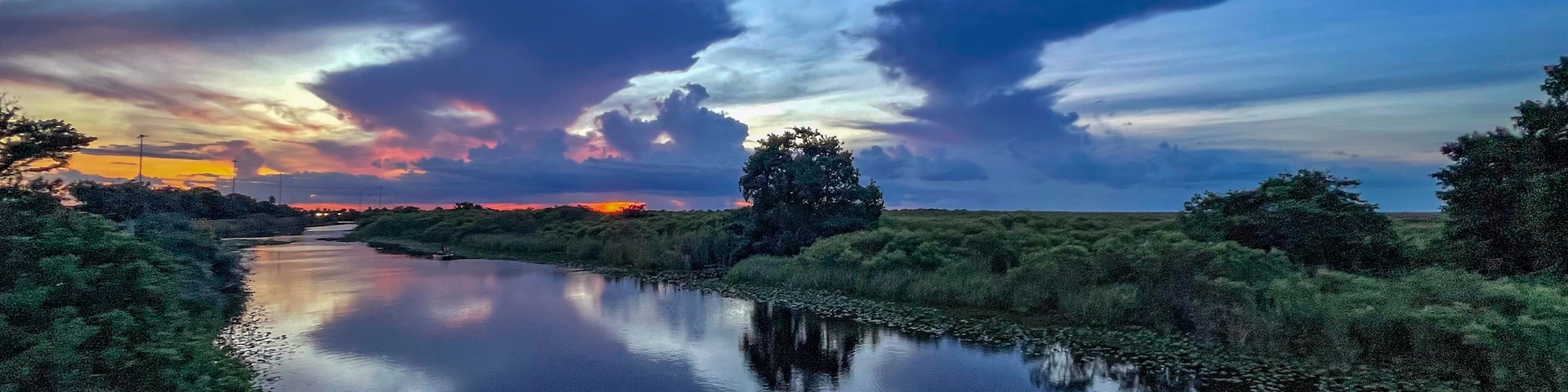 Swamp sunset and hurricane clouds