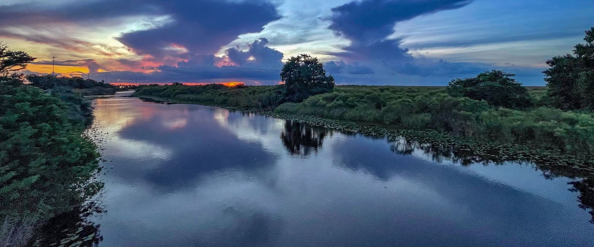 Swamp sunset and hurricane clouds
