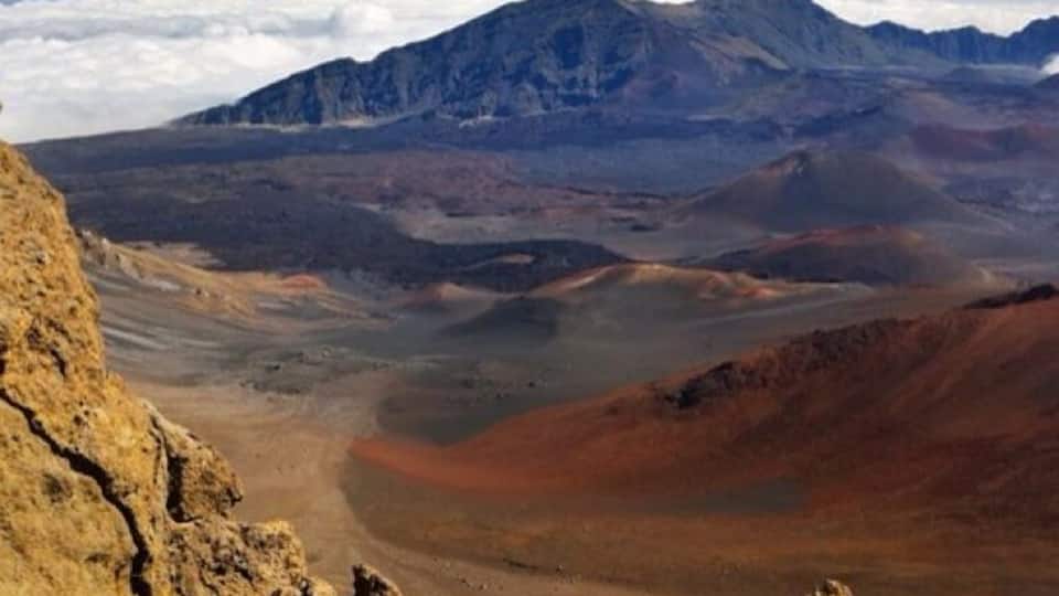 A mountainous landscape with rocky terrain and a valley.