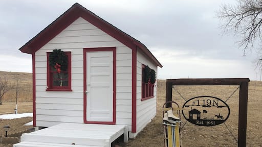 Tiny one room rural school that has been total restored to the original by historian neighbor lady. This school was built on skids and was pulled by team of horses to were ever the most children was in the district.
