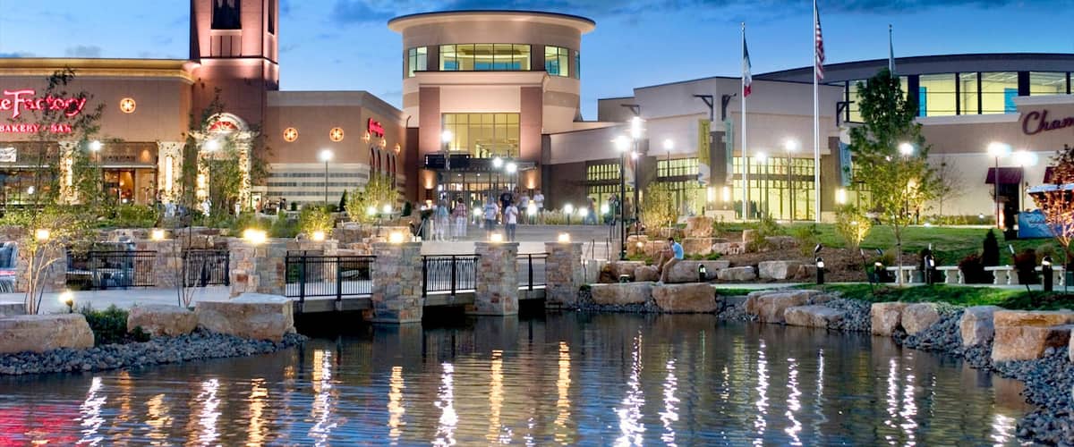 West Des Moines featuring a lake or waterhole, shopping and modern architecture