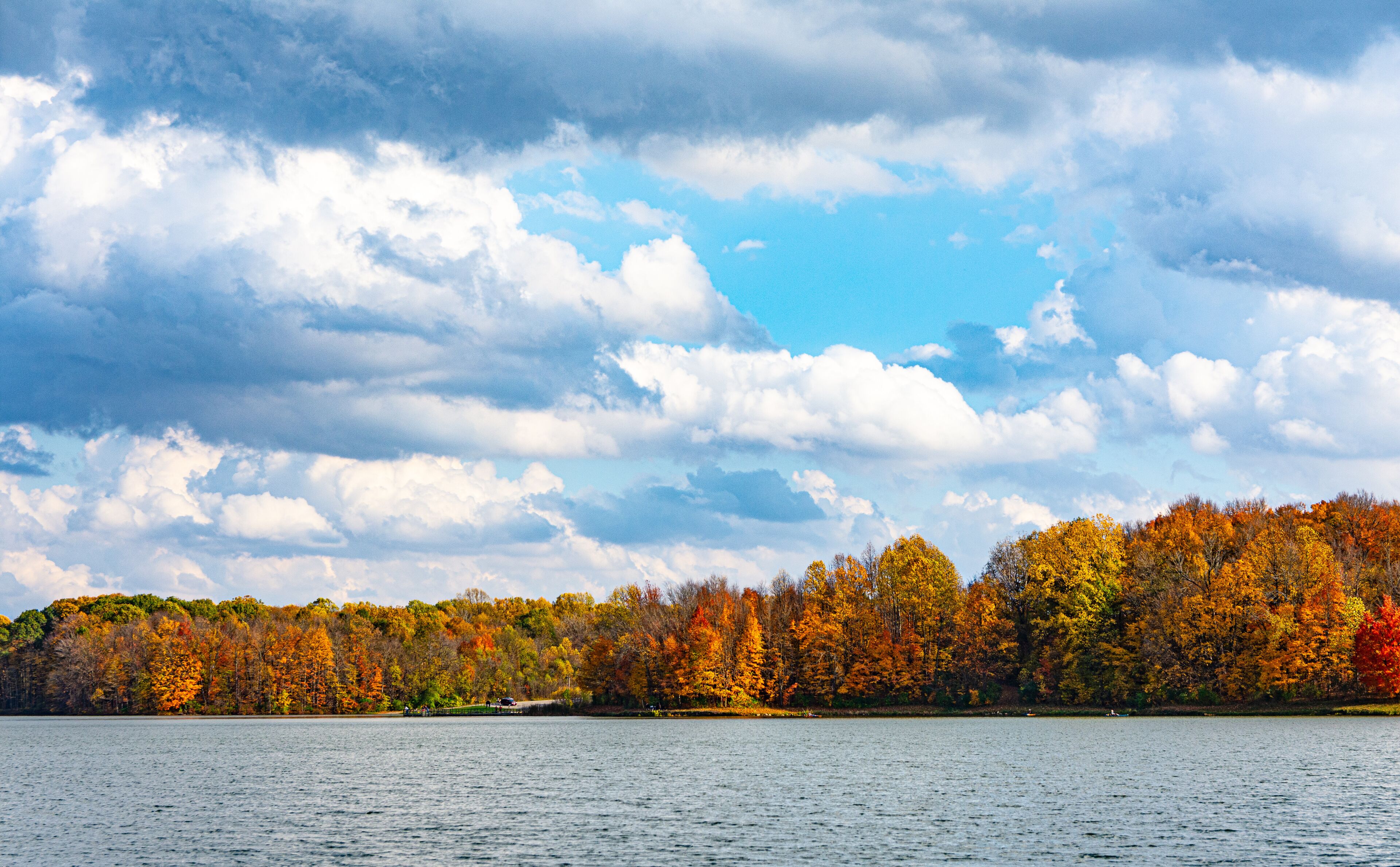 Brightly colored trees of autumn line the shore of Worster Lake at Potato Creek State Park in North Liberty, Indiana