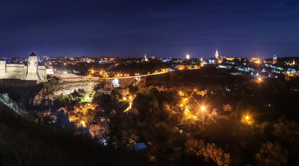 Panoramic night view of ancient fortress castle in Kamianets-Podilskyi, Khmelnytskyi Region, Ukraine. Old ?astle photo on a postcard or cover. Long exposive