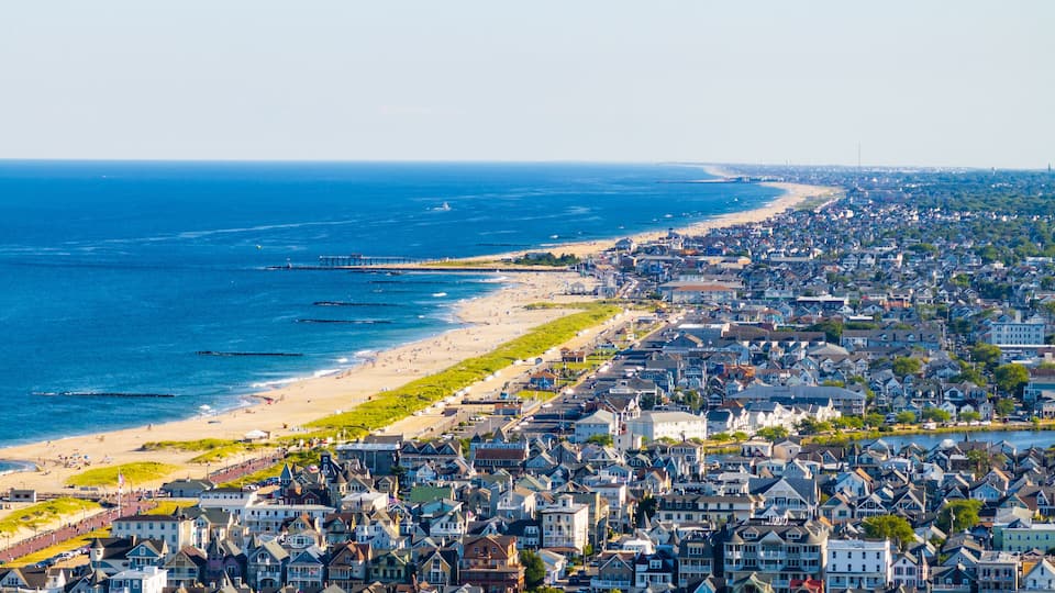 A coastal town with a beach, ocean, and densely packed houses.